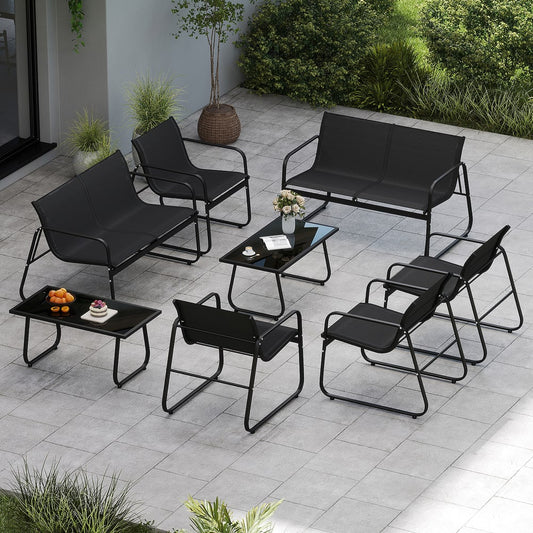The patio furniture sets arranged on a paved garden terrace with plants and snacks