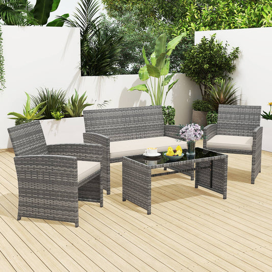 The patio furniture set arranged on a wooden deck with plants