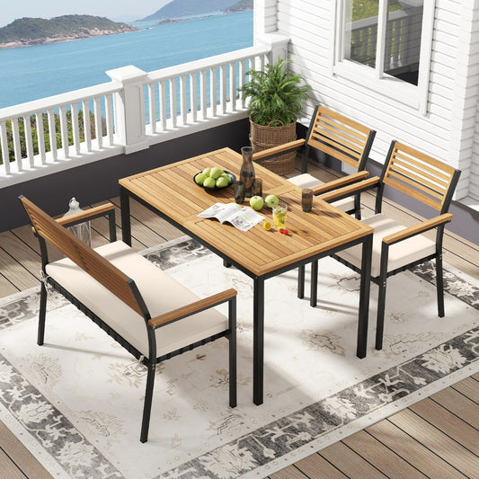 The outdoor wood metal furniture set arranged on a balcony with a sea view