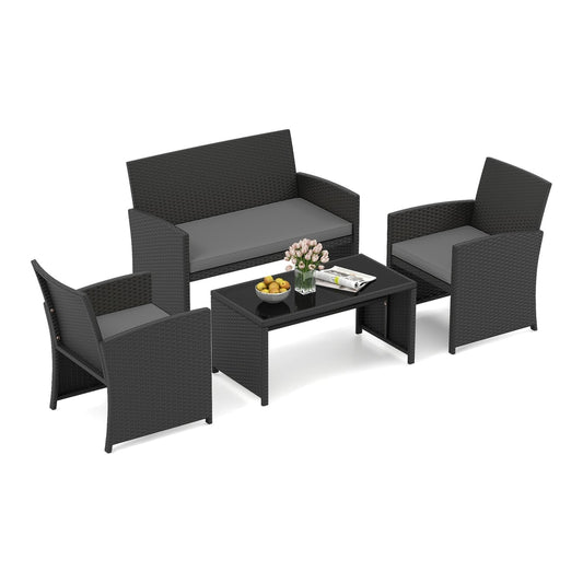4 Piece Patio Rattan Conversation Set Wicker Loveseat Armchairs with grey cushions and a glass topped coffee table