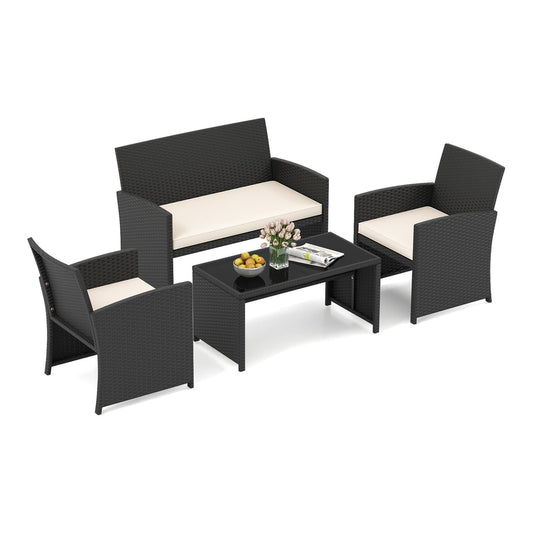 4 Piece Patio Rattan Conversation Set Wicker Loveseat Armchairs with cream cushions and a glass topped coffee table