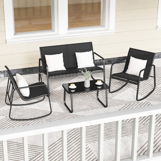 The patio furniture set arranged on a balcony with white cushions and a coffee table