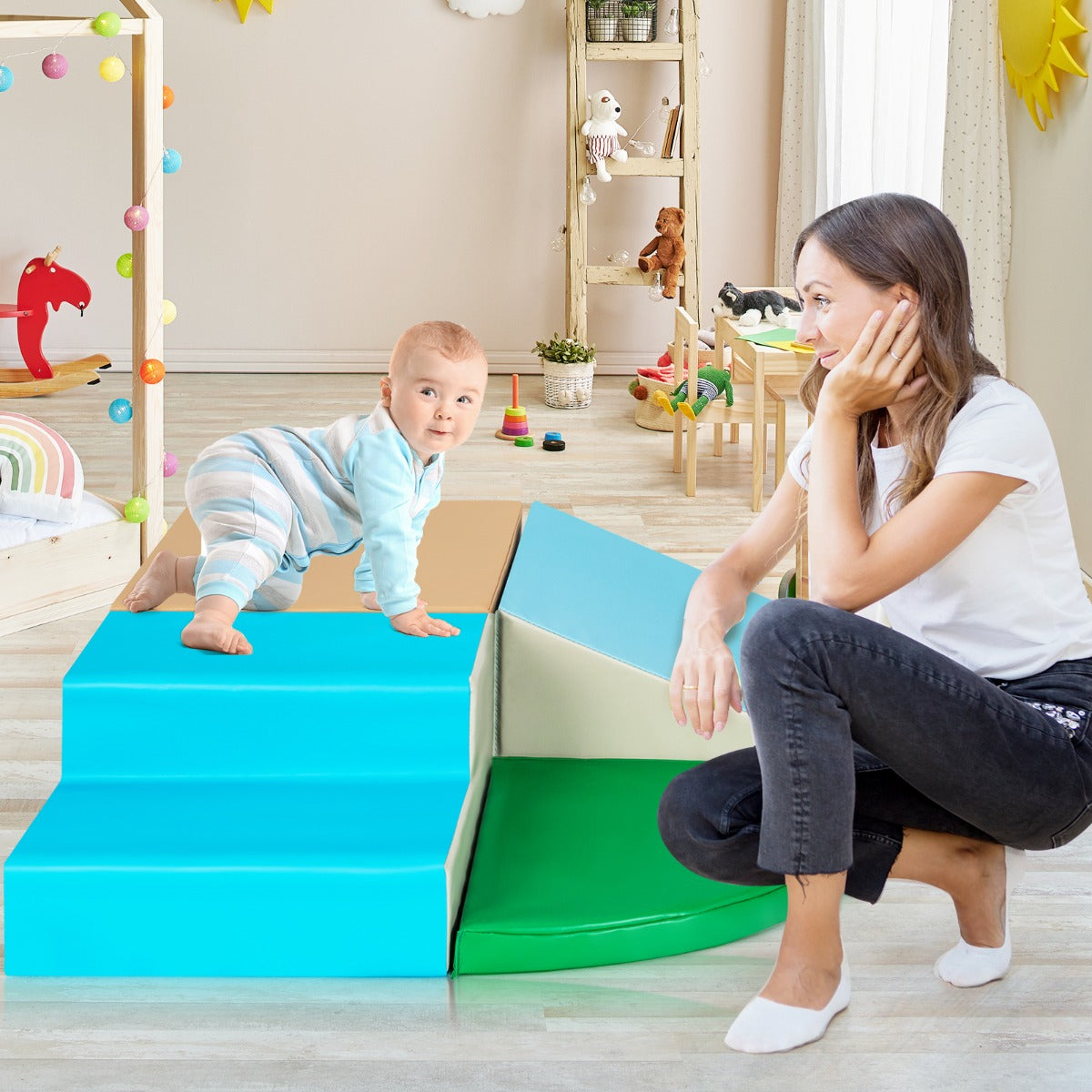 Mother and baby playing on the soft play set in a living room