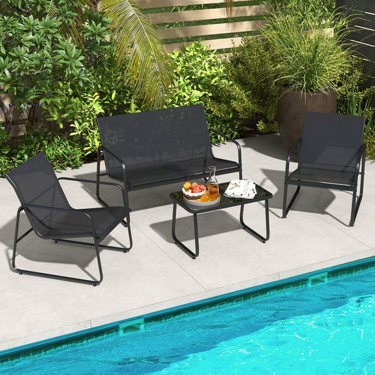 Black patio furniture set with two chairs, a sofa and a coffee table beside a swimming pool
