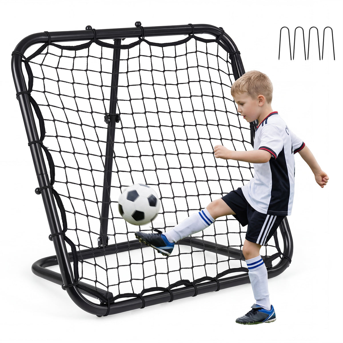 A boy kicks a football towards the bounce back net on a lawn