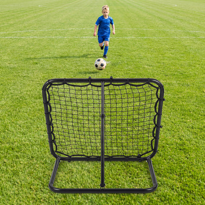 A child runs towards the bounce back net on a football pitch to receive a ball