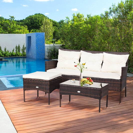 The rattan garden furniture set with cushions by a swimming pool