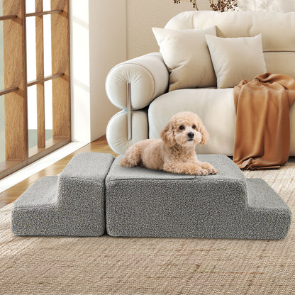 A small poodle lying on the grey foam dog steps in a living room setting