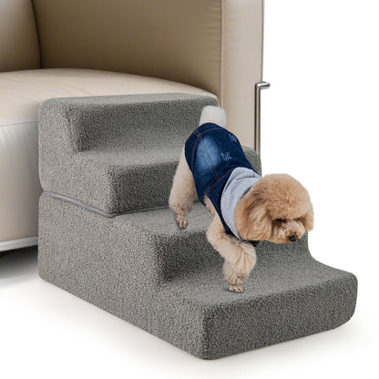 Small dog wearing a denim jacket walking down the grey foam dog steps next to a sofa