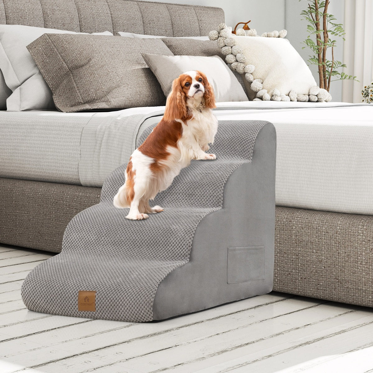 The grey pet steps positioned beside a bed with a small dog standing on the top tier