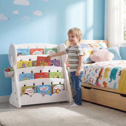 A young boy reaching for a book on the kids storage unit in a bedroom