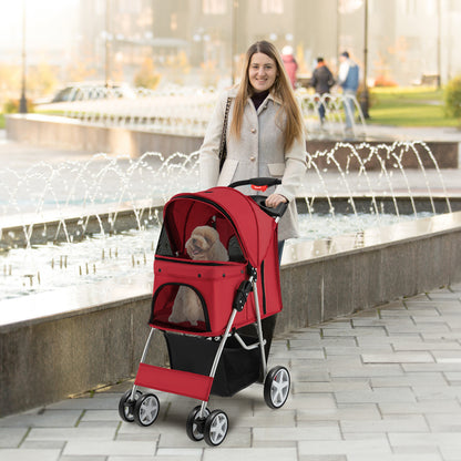 A woman pushes a red four-wheel pet stroller with a dog inside near a fountain
