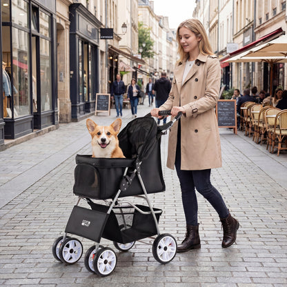 The dog stroller being pushed by a woman on a city street with a small dog sitting inside