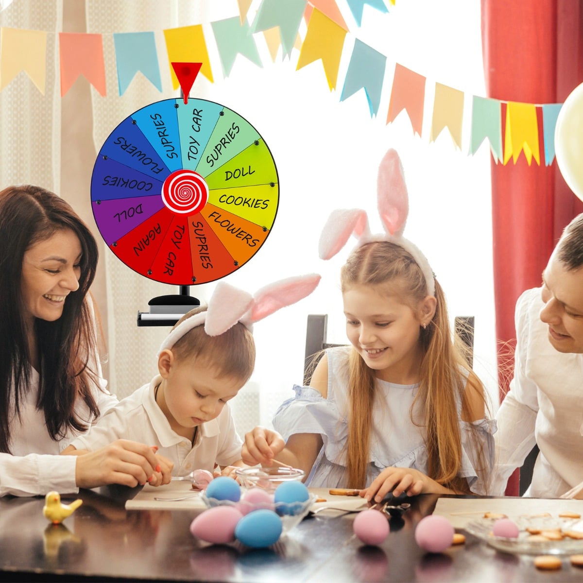The prize wheel displayed on a table during a festive party with a child and adults