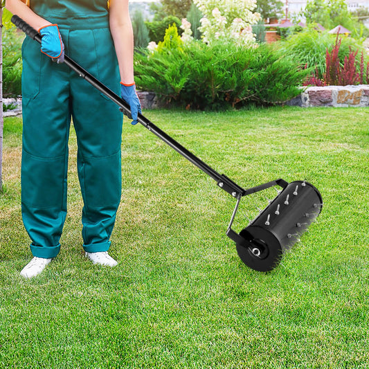 The lawn care tool being pushed across a green grass lawn by a gardener