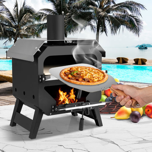 The outdoor grill in use with a pizza being placed inside by a hand on a wooden peel