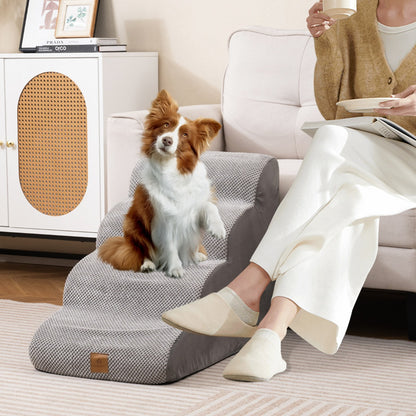 The dog ramp with a dog sitting on it next to a sofa and a person