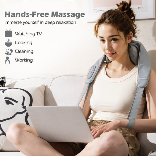 Grey neck and shoulder massager being used hands-free while a woman uses a laptop