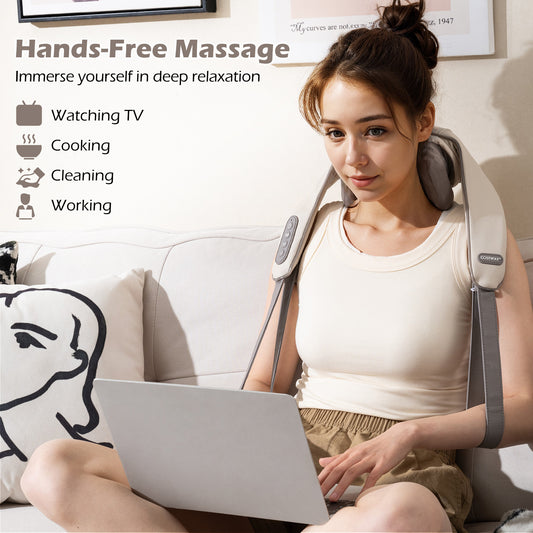 The neck massager worn by a woman using a laptop on a sofa for hands-free relaxation