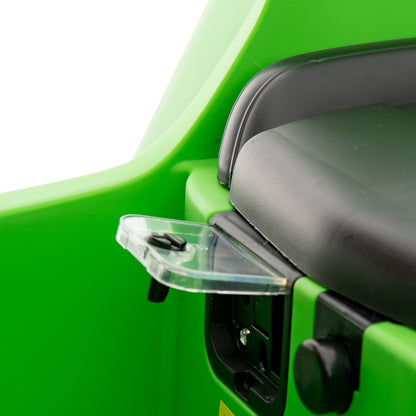 Close-up of the clear flap covering the charging port on the green kids electric sports car