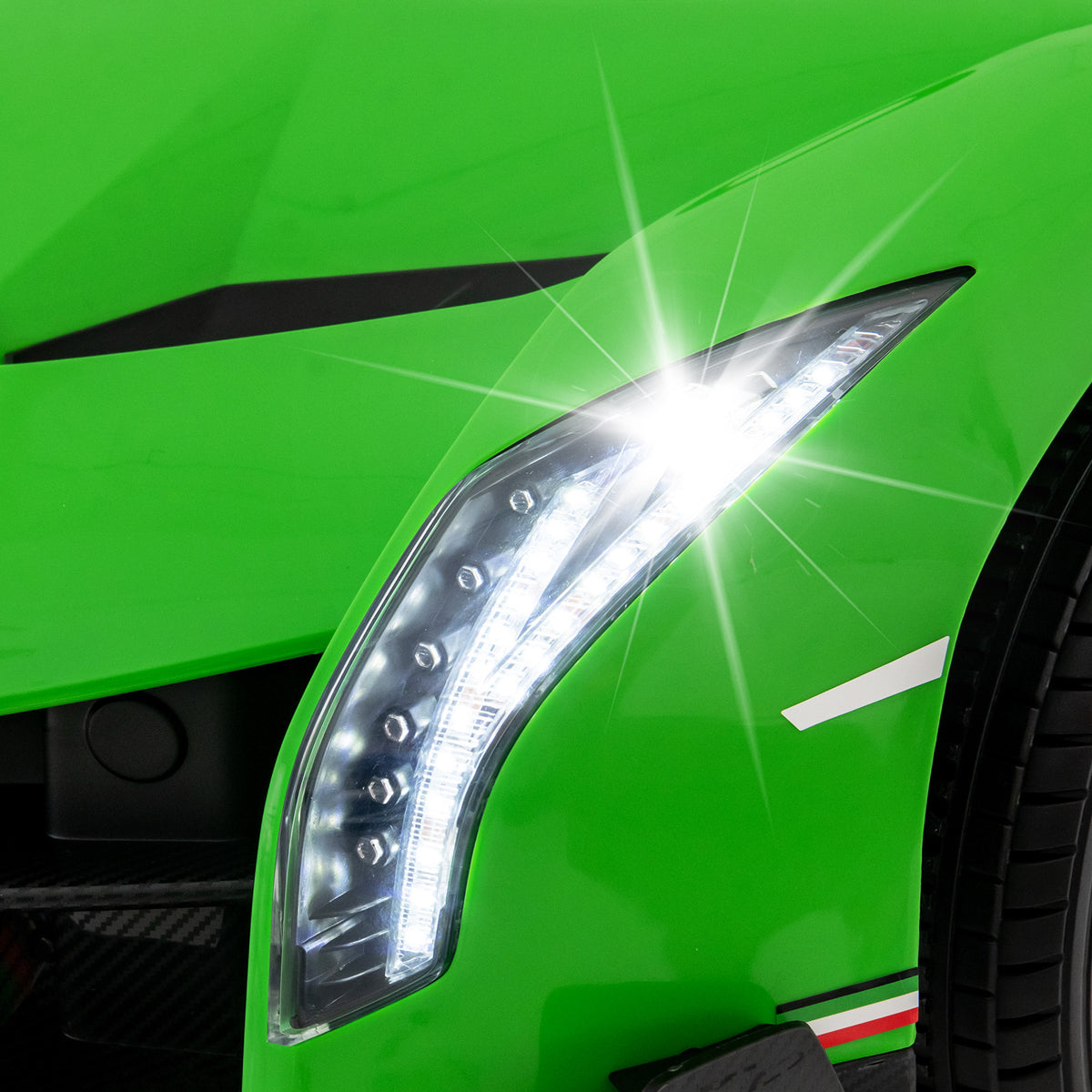 Close-up of the bright LED headlight on the green kids electric sports car