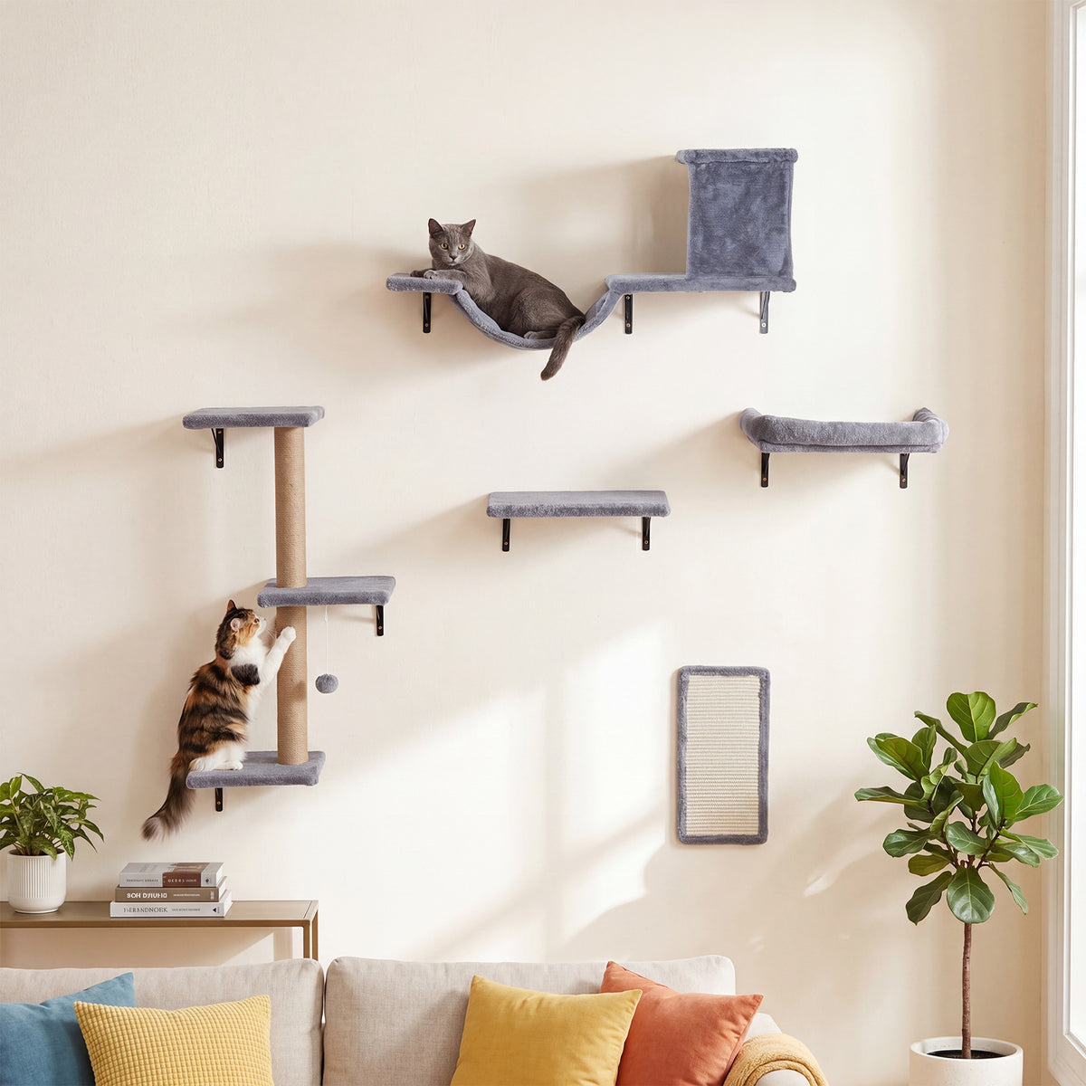 The cat furniture mounted on a living room wall with two cats playing and resting on the platforms
