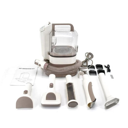 The pet grooming vacuum kit laid out with all its attachments and instruction manual