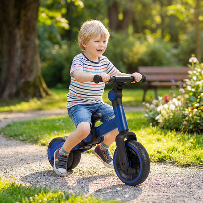 A happy young boy rides the blue balance bike in a park