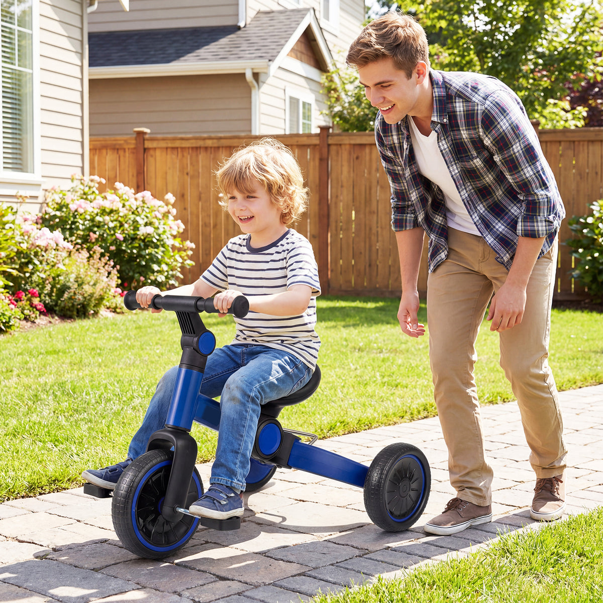 A father watches his son ride the blue balance bike on a garden path