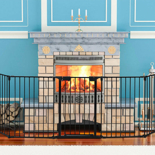 The baby safety playpen set up as a fireplace barrier in front of a lit fireplace