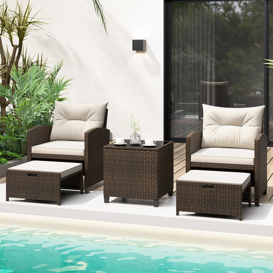 The patio furniture set with ottomans and coffee table arranged by a swimming pool