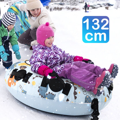 Two children and an adult enjoying a blue dinosaur patterned snow tube on a snowy slope