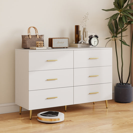 The white six drawer dresser is shown in a living room with a robot vacuum cleaner