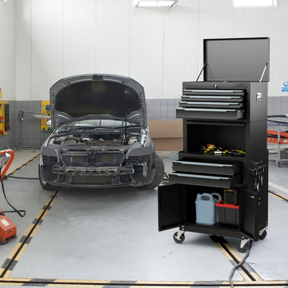 The tool chest placed in a car repair garage with the top lid and bottom cabinet doors open