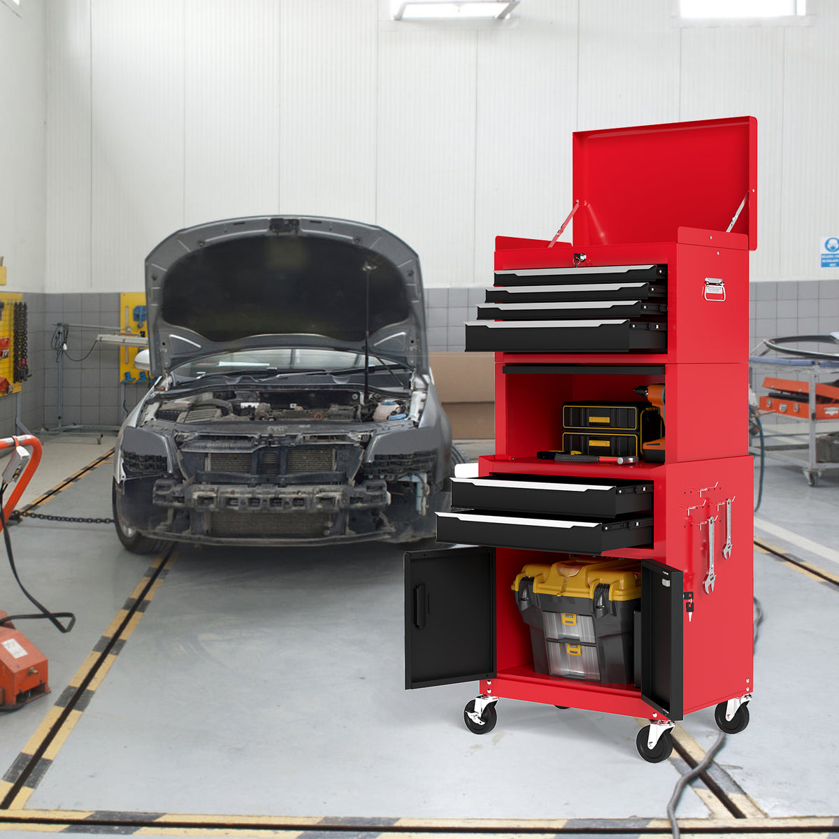 The red and black rolling tool chest in a garage setting with a car