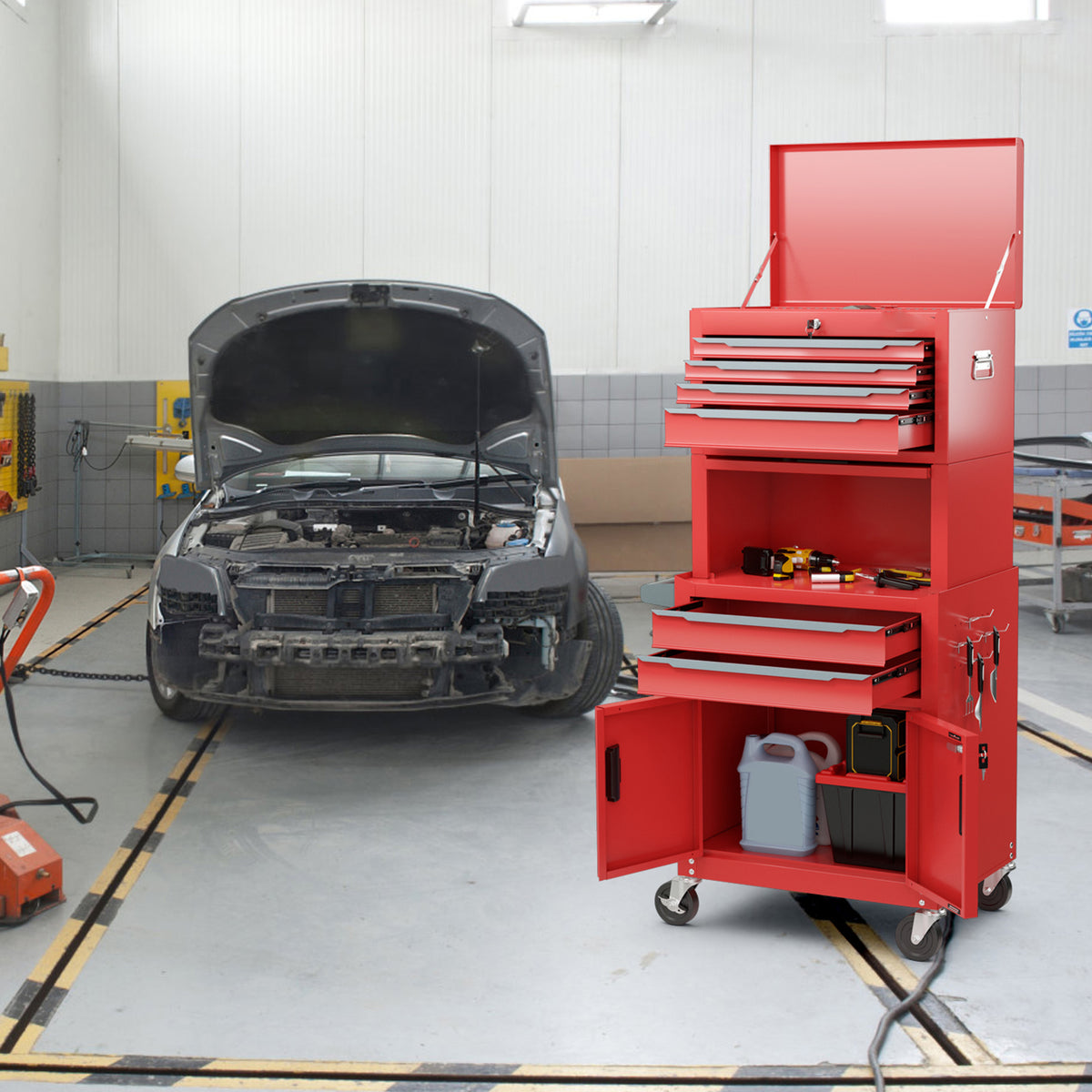 The rolling tool cabinet with open drawers and doors in a car repair garage
