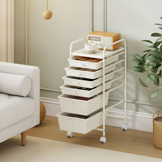 The white storage trolley with drawers is shown in a living room setting next to a sofa