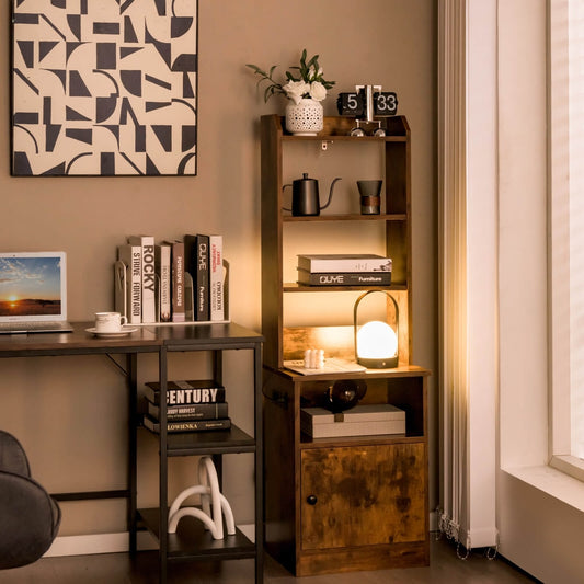 The tall nightstand placed in a home office next to a desk with books and a lamp