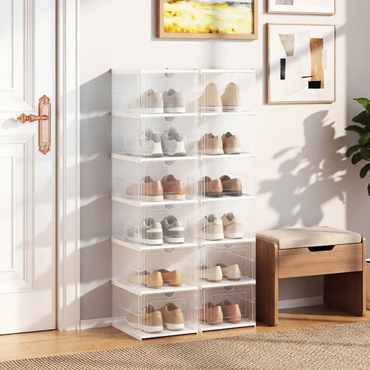 The shoe rack set in a hallway, with shoes stored inside the clear boxes, next to a door and a bench