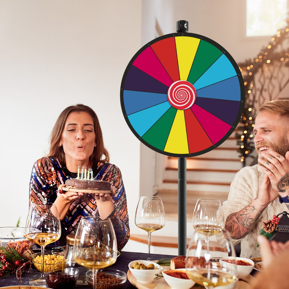 The prize wheel being used at a birthday party with people celebrating