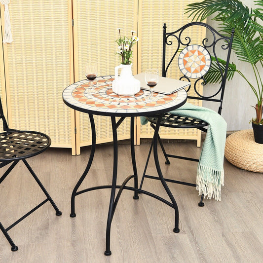The patio table set up in a room with two chairs and a vase of flowers