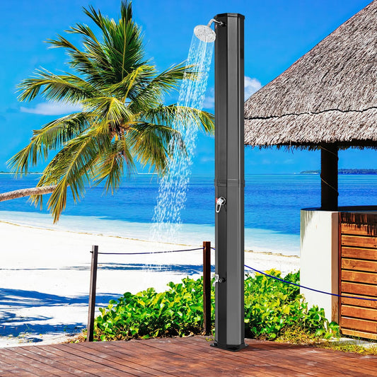 The outdoor shower is shown on a wooden deck by the sea