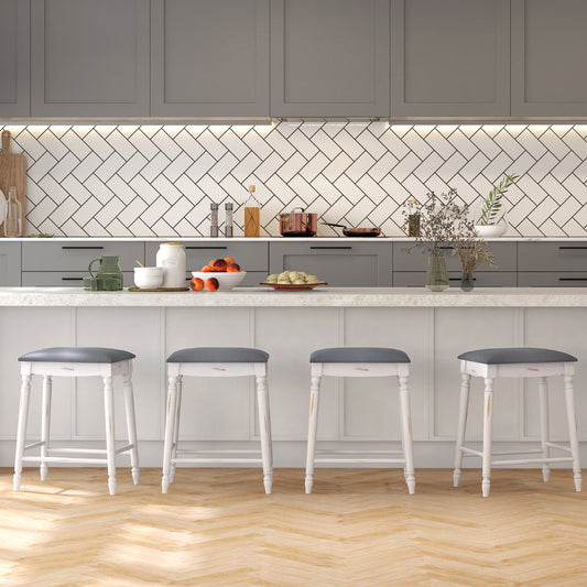 The bar stools arranged in a row along a kitchen island in a modern home interior