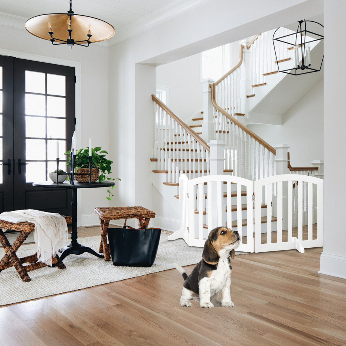 61 cm Height Safety Fence, the pet gate placed at the bottom of a wooden staircase in a bright hallway with a puppy