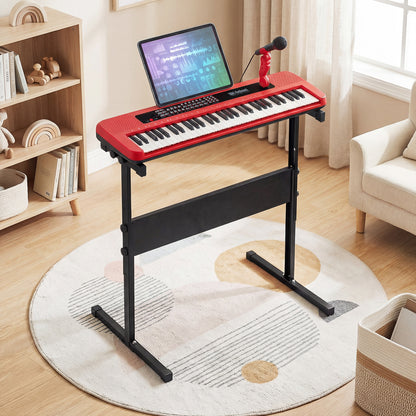 The red kids electric piano keyboard on its stand in a bright room with a rug and shelves