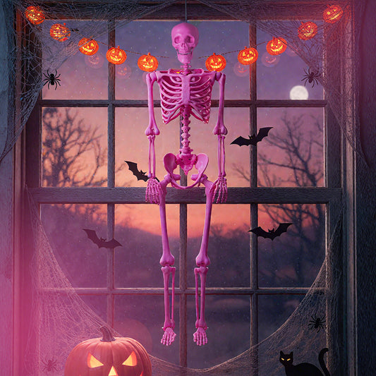 The Halloween skeleton decoration hanging in a window with pumpkins and cobwebs