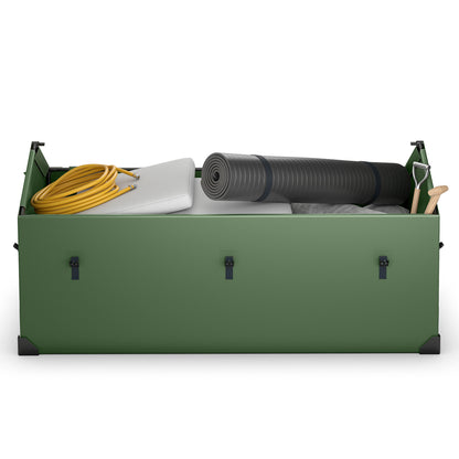 Inside the green outdoor storage box, showing a rolled-up mat, a yellow hose, a white cushion and a small shovel