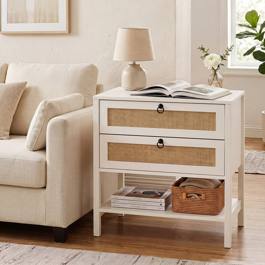 The white boho rattan nightstand in a living room next to a sofa