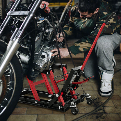 The motorcycle lift jack positioned under a motorbike while a person performs repairs