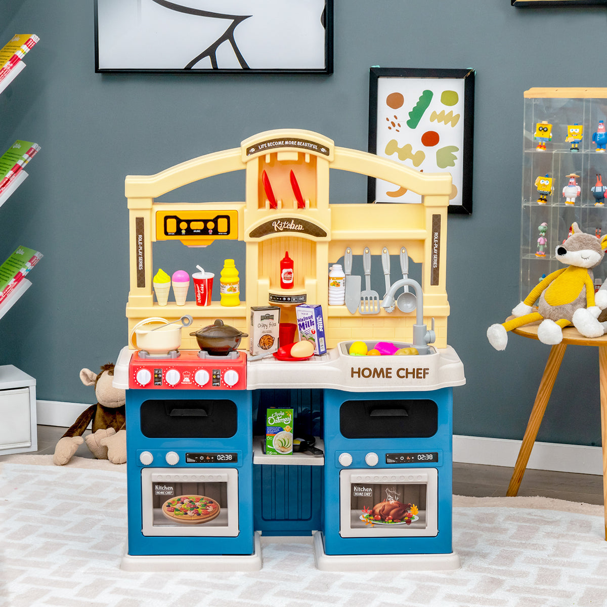 Blue and yellow play kitchen set in a room with toys and decorations